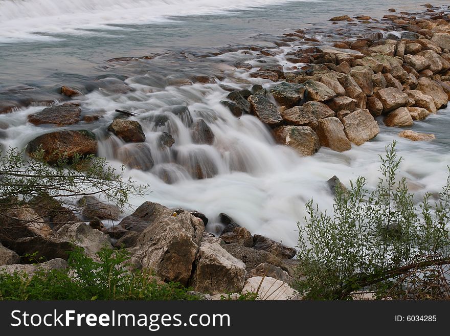 Photo of a small waterfall of a torrent. Photo of a small waterfall of a torrent.