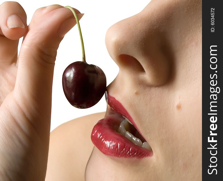 Young girl to eat cherry. Isolated