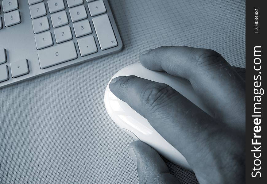 Hand on computer mouse