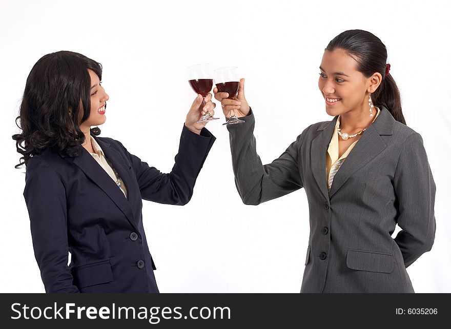 Beautiful female co-workers doing a wine toast