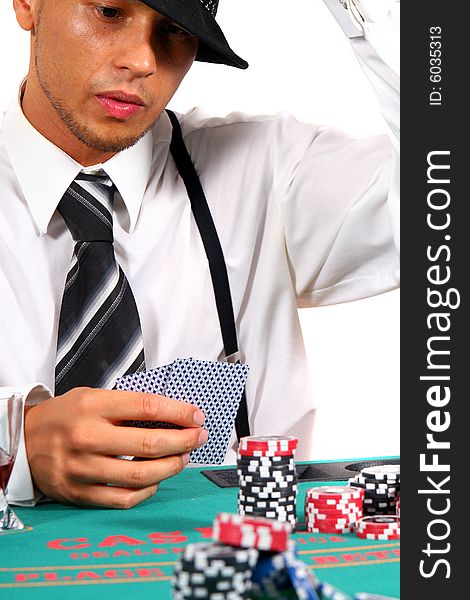 Young man playing poker with a hat and stylish suit. Isolated over white background. Young man playing poker with a hat and stylish suit. Isolated over white background.