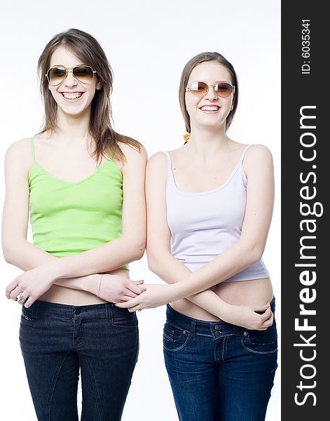 Two young smiling girls on white background. Two young smiling girls on white background