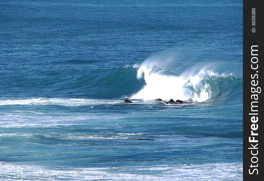 Curling Wave Breaking Over Dry Rock