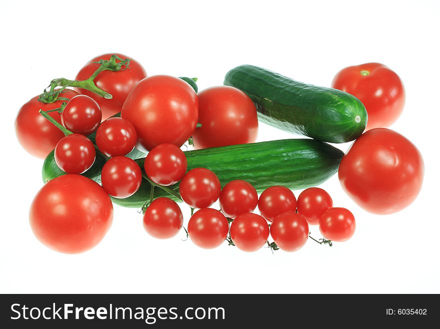Tomatoes and cucumbers on a white background. Tomatoes and cucumbers on a white background.