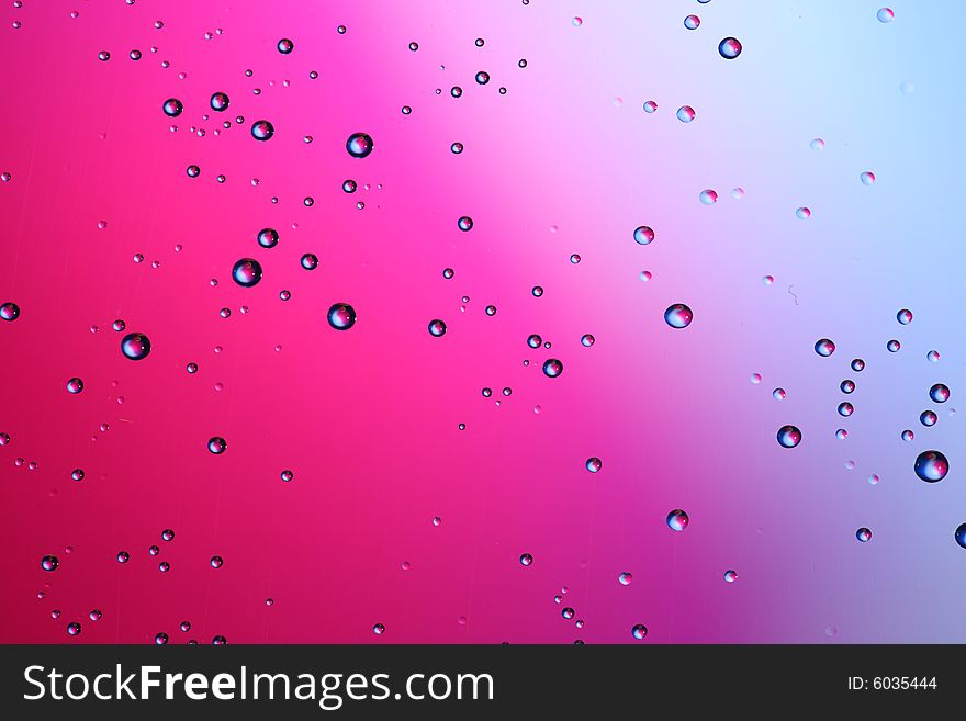 Drops of water on a red, blue background. Drops of water on a red, blue background.