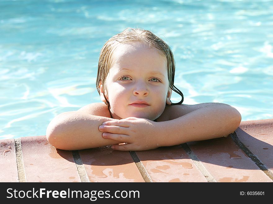 Young girl learning how to swim using a float. Young girl learning how to swim using a float