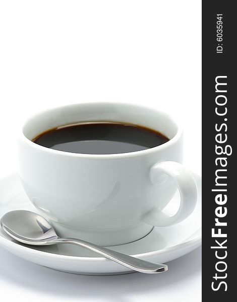 Hot cup of black coffee with a spoon on a white background