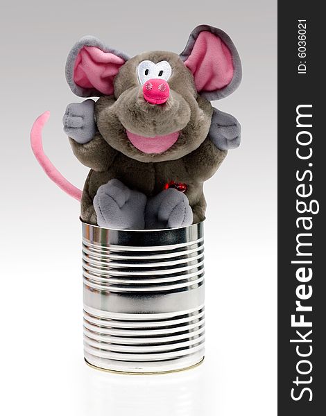 An isolated view of a toy stuffed animal resembling an elephant or rat in a tin can. An isolated view of a toy stuffed animal resembling an elephant or rat in a tin can.