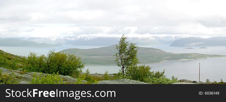 Water, snow, mountains, islands, rocks, the ingredients of the fjords landscape in the north of Norway / Lapland.