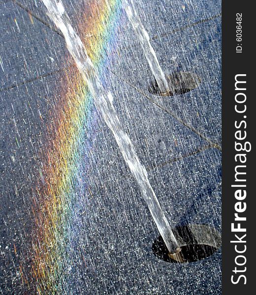 Fountain water sprays creating a rainbow