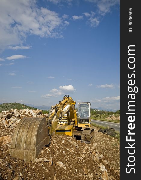 Old excavator on the municipal waiting next working day.