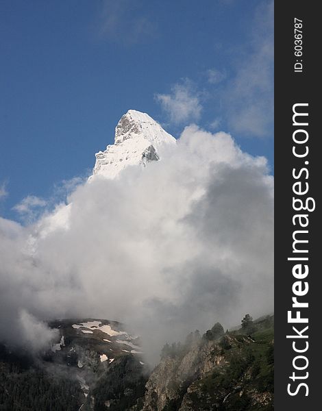 Matterhorn in the morning, emerging from the clouds. Matterhorn in the morning, emerging from the clouds