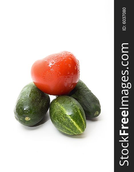 Cucumbers and tomato on white background