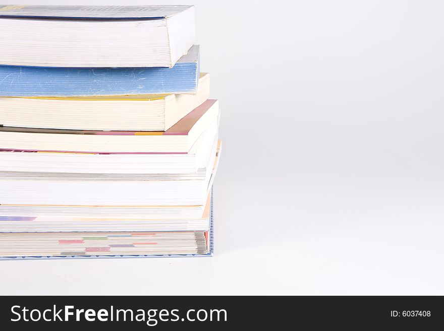 Stack of many books on the white background. Stack of many books on the white background