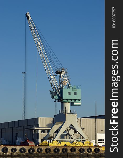 Harbour crane and warehouse at an industrial port