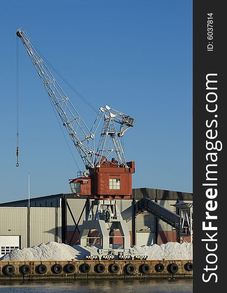 Harbour crane and warehouse at commercial port