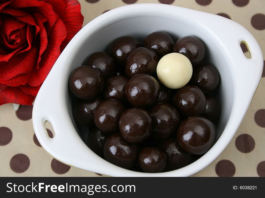 Vanilla and Dark Chocolate balls on a dotty background