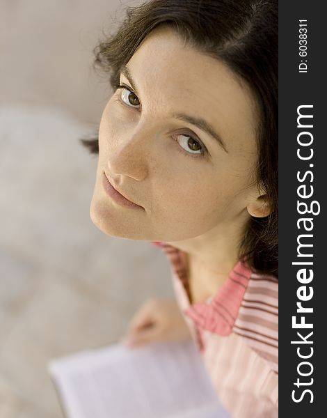 Close up portrait of young woman with a book