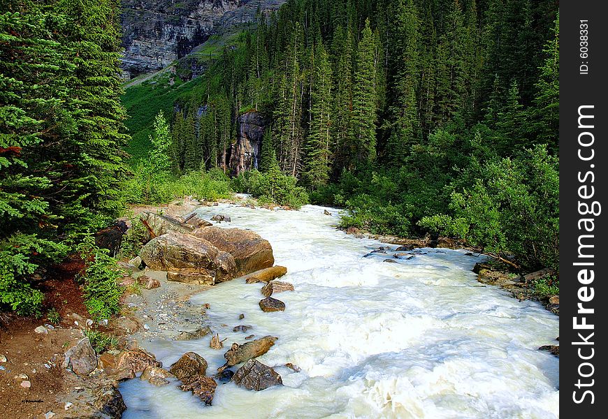 Fast moving river in the Canadian Rockies after a hard rain.  The little stream turned into rapids. Fast moving river in the Canadian Rockies after a hard rain.  The little stream turned into rapids.