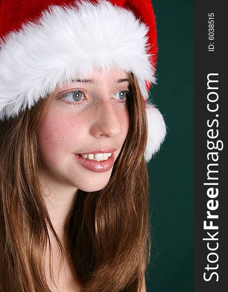 Brunette Teenager wearing a fluffy christmas hat