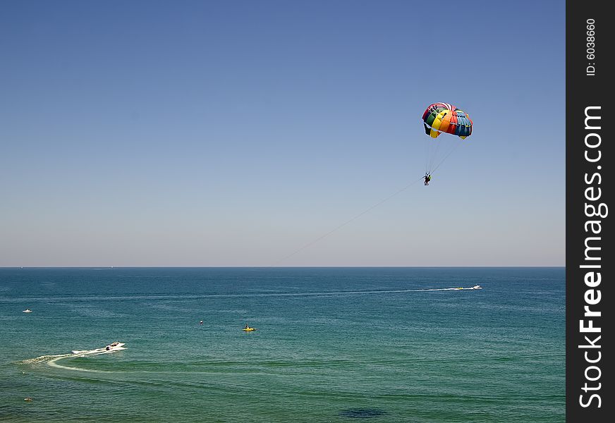 Two people parasailing against a Black Sea sky. Two people parasailing against a Black Sea sky