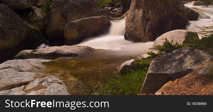 A bend in a rocky mountain river rushing with spring runoff. A bend in a rocky mountain river rushing with spring runoff.