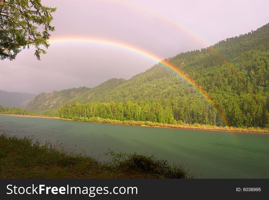 Rainbow above river in mountains