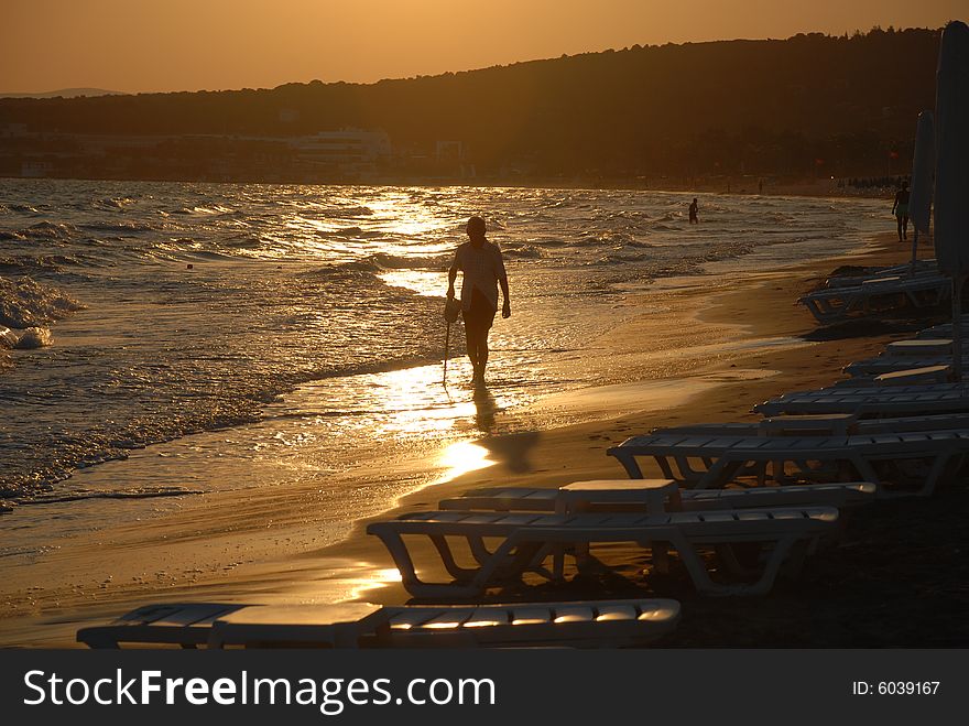 Sunrise on the beach by beach umbrellas and lounge