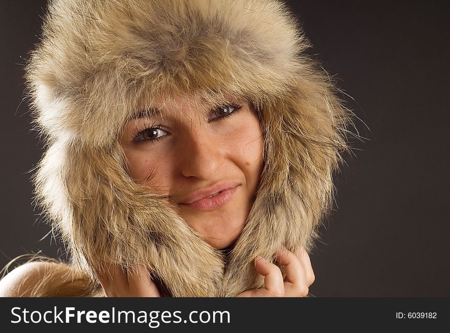 Girl with fur hat, studio photo