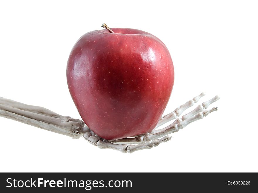 Skeleton hand holding an apple. Skeleton hand holding an apple