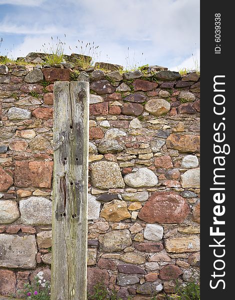 Old railway sleeper mounted near sandstone wall. Old railway sleeper mounted near sandstone wall