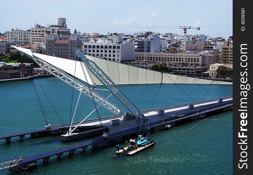 The modern pier of San Juan city with the oldtown in a background (Puerto Rico). The modern pier of San Juan city with the oldtown in a background (Puerto Rico).