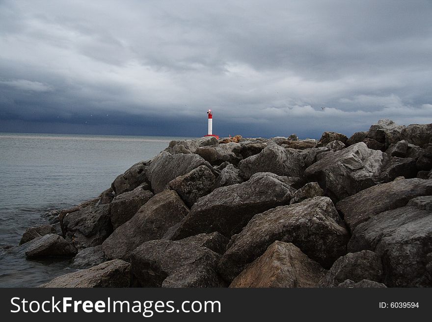 Lighthouse overlooking Lake Ontario in stormy weather. Lighthouse overlooking Lake Ontario in stormy weather