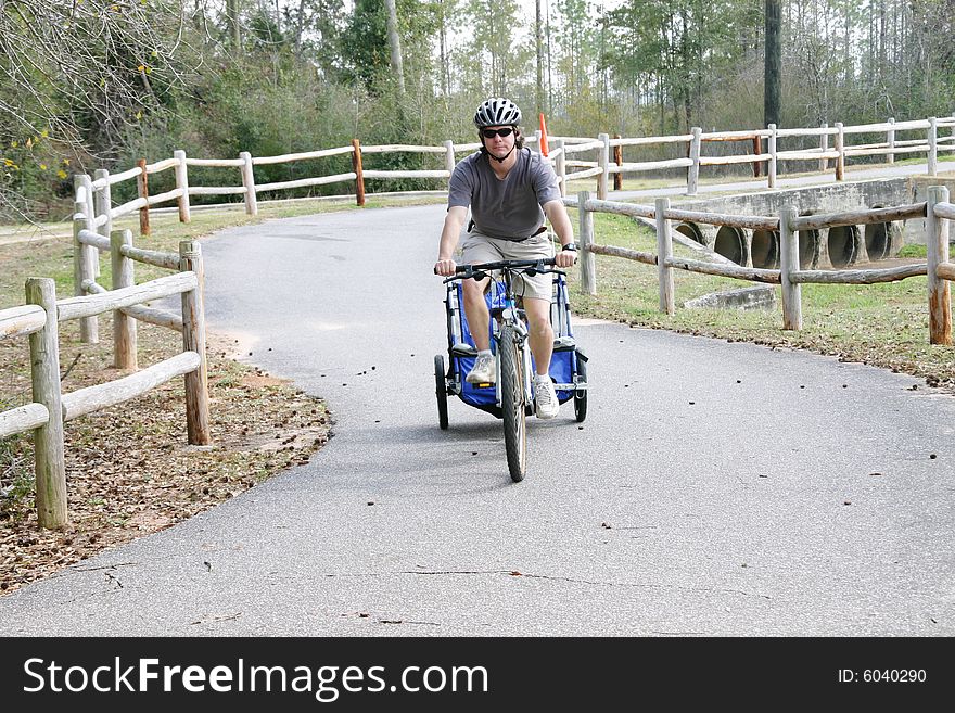 Caucasian father and son enjoying a bike ride on a country bike trail. Caucasian father and son enjoying a bike ride on a country bike trail