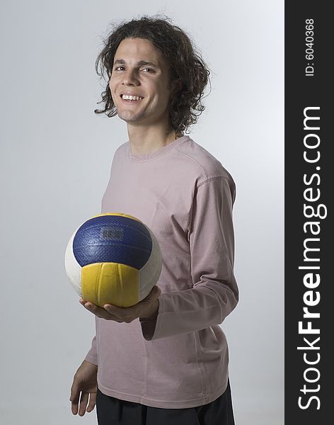 Man Posing In Studio With Volleyball - Vertical