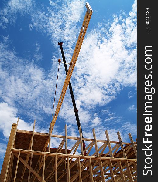 Construction site with scaffolding and a crane. Vertically framed photo. Construction site with scaffolding and a crane. Vertically framed photo.