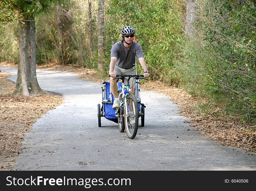 Caucasian father and son enjoying a bike ride on a country bike trail. Caucasian father and son enjoying a bike ride on a country bike trail