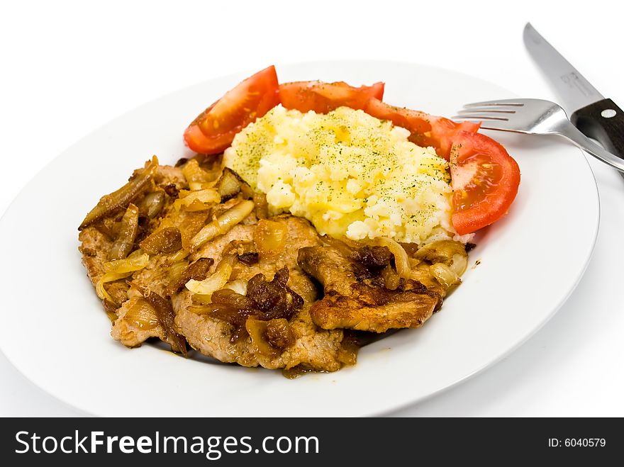 Roasted pork cutlet with puree and tomato salad.