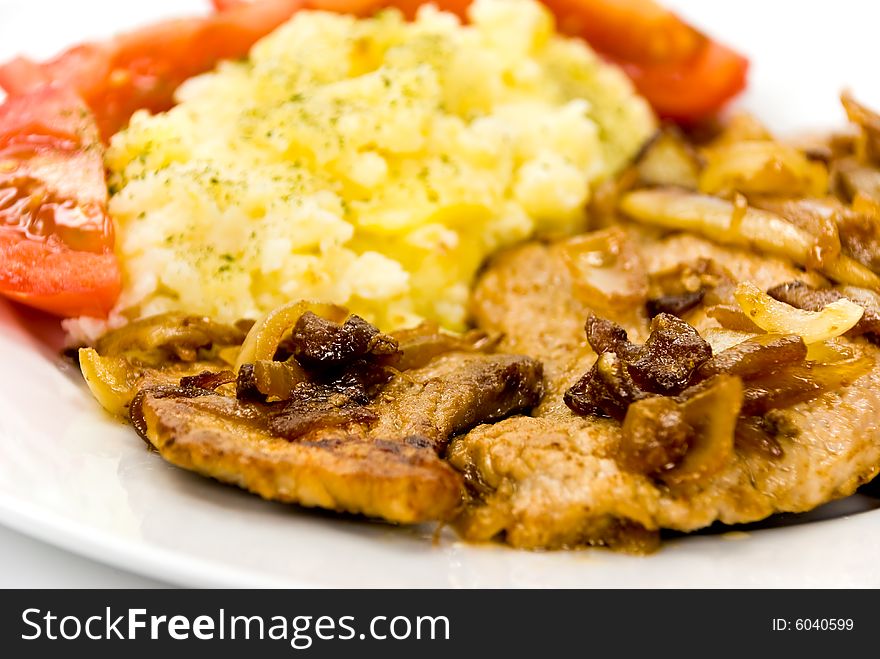 Roasted pork cutlet with puree and tomato salad