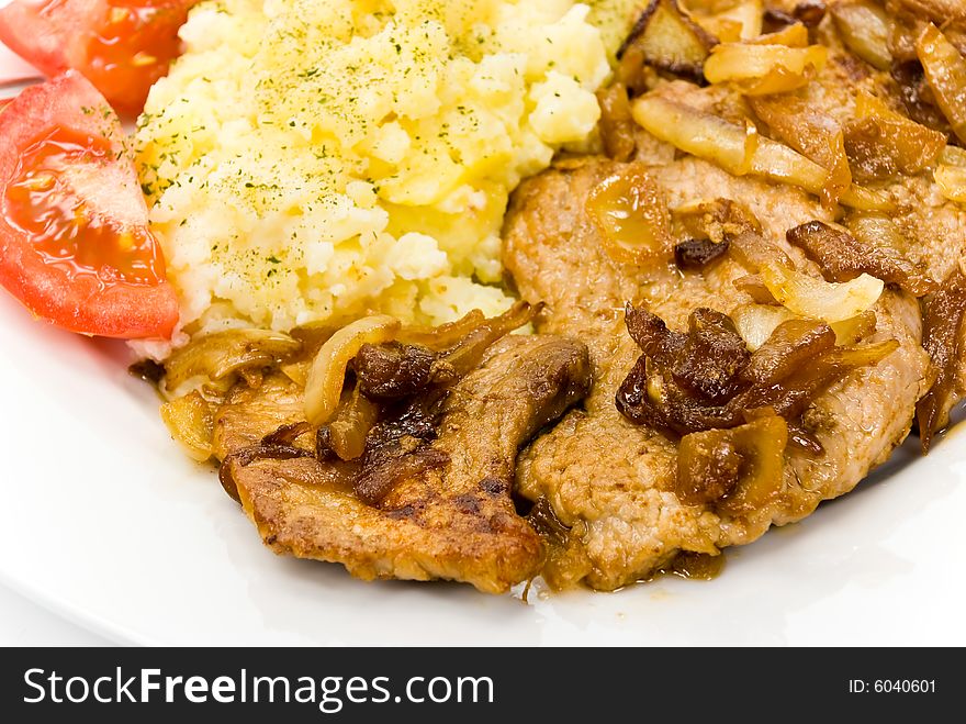 Roasted pork cutlet with puree and tomato salad.