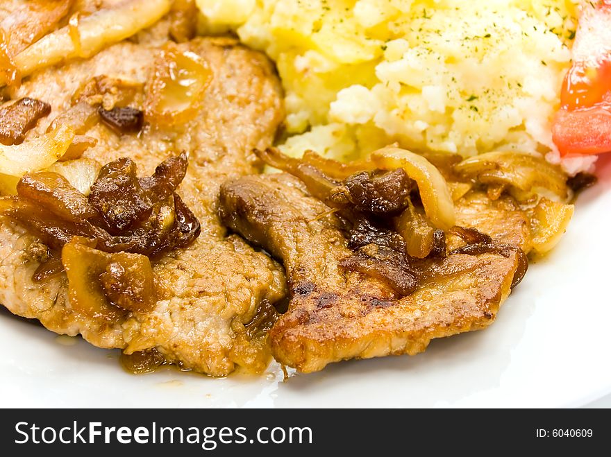 Roasted pork cutlet with puree and tomato salad