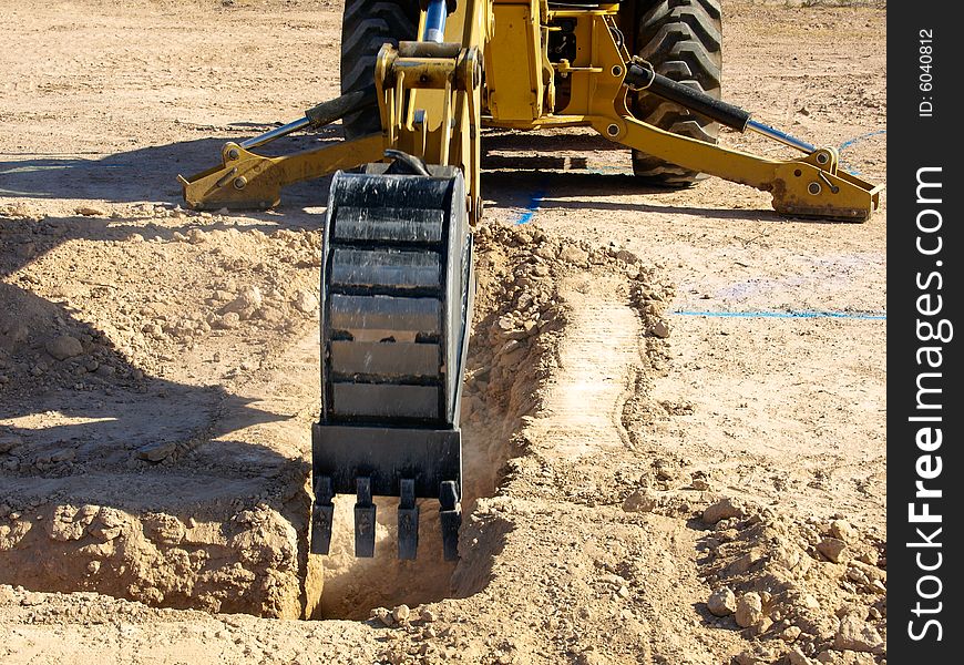 A giant steam shovel is digging into the dirt.  Horizontally framed shot. A giant steam shovel is digging into the dirt.  Horizontally framed shot.