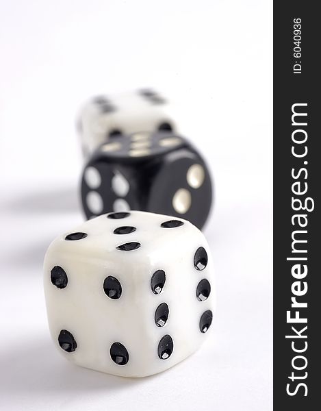 Black and white dice on a white background with selective focus. Black and white dice on a white background with selective focus