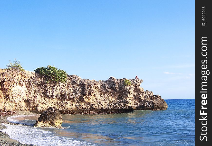A beach surrounded by rocks located at the southern coast of Cuba, in Guantanamo province. A beach surrounded by rocks located at the southern coast of Cuba, in Guantanamo province.