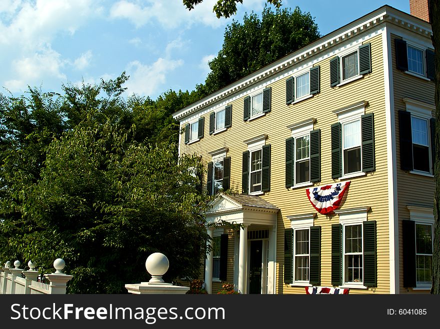 Classic massachusetts home with patriotic buntings and shutters