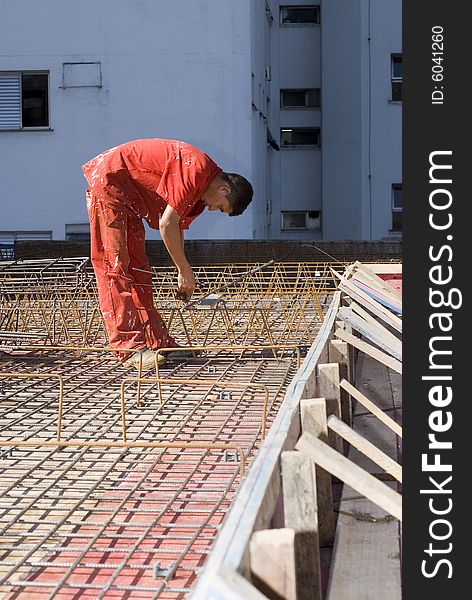 Construction Worker Installs Rebar - Vertical