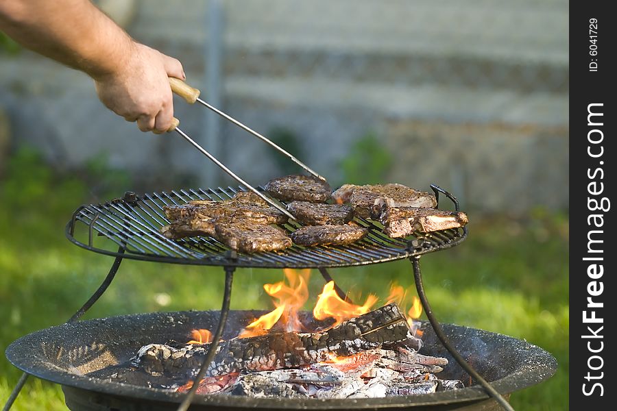 Man Barbecuing Meat
