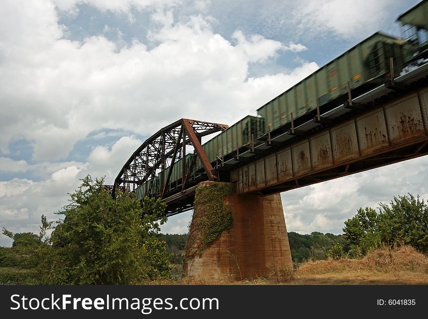 Shot of train crossing railroad bridge.