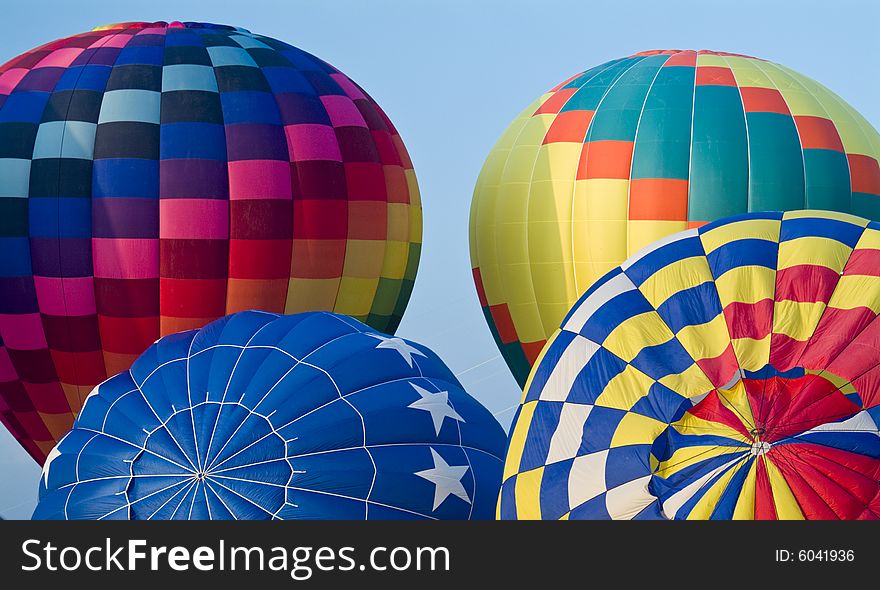 A colorful hot air balloon floating in a bright blue sky. A colorful hot air balloon floating in a bright blue sky.