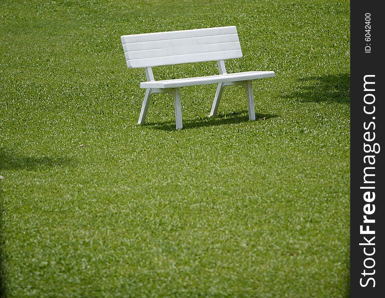 A simple picture with grass and bench. A simple picture with grass and bench